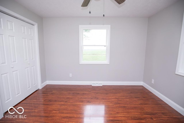 7950 N 475 E, Columbus, IN 47203 - unfurnished bedroom featuring dark wood-type flooring, a closet, and ceiling fan