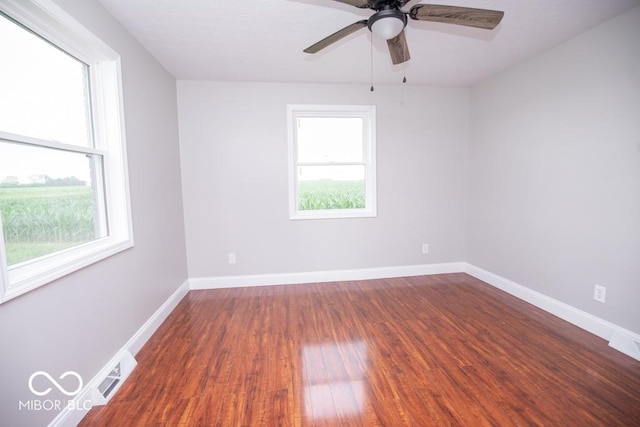 7950 N 475 E, Columbus, IN 47203 - empty room with healthy amount of natural light, dark wood-style flooring, and ceiling fan