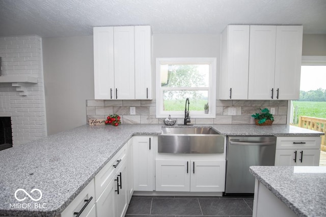 7950 N 475 E, Columbus, IN 47203 - kitchen featuring dishwasher, tasteful backsplash, dark tile patterned floors, white cabinetry, and a textured ceiling