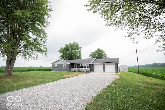 7950 N 475 E, Columbus, IN 47203 - ranch-style home featuring gravel driveway, an attached garage, a front yard, and a shed