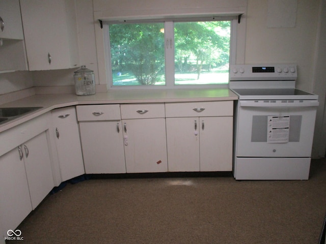302 Lincoln St, Crawfordsville, IN 47933 - kitchen featuring electric stove, light countertops, and white cabinetry