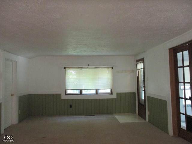 302 Lincoln St, Crawfordsville, IN 47933 - empty room featuring wainscoting, a textured ceiling, and carpet floors