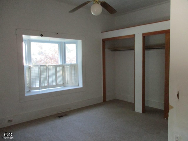 302 Lincoln St, Crawfordsville, IN 47933 - unfurnished bedroom with multiple closets, carpet flooring, and a ceiling fan