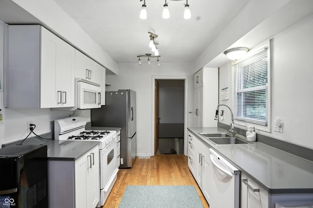 5560 Royal Oak Ct, Indianapolis, IN 46227 - kitchen featuring white appliances, light wood-style flooring, dark countertops, white cabinets, and rail lighting