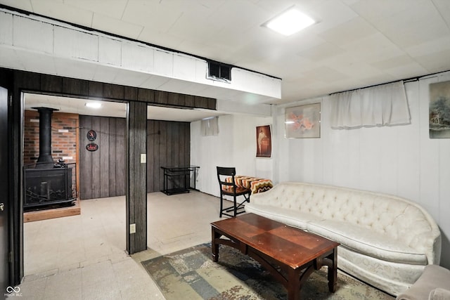 5560 Royal Oak Ct, Indianapolis, IN 46227 - living area featuring tile patterned floors, wood walls, and a wood stove