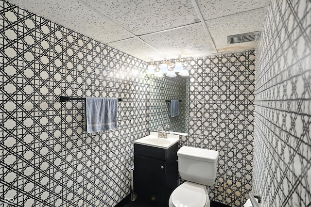 5560 Royal Oak Ct, Indianapolis, IN 46227 - bathroom featuring a paneled ceiling, tile walls, and vanity