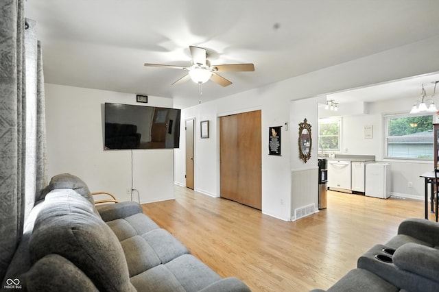 5560 Royal Oak Ct, Indianapolis, IN 46227 - living area with light wood-style floors, ceiling fan, and a chandelier