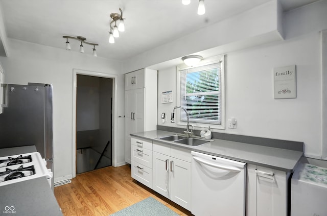 5560 Royal Oak Ct, Indianapolis, IN 46227 - kitchen with dishwasher, white cabinetry, light wood finished floors, freestanding refrigerator, and range