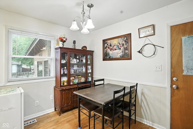 5560 Royal Oak Ct, Indianapolis, IN 46227 - dining room with a chandelier and light wood-style flooring