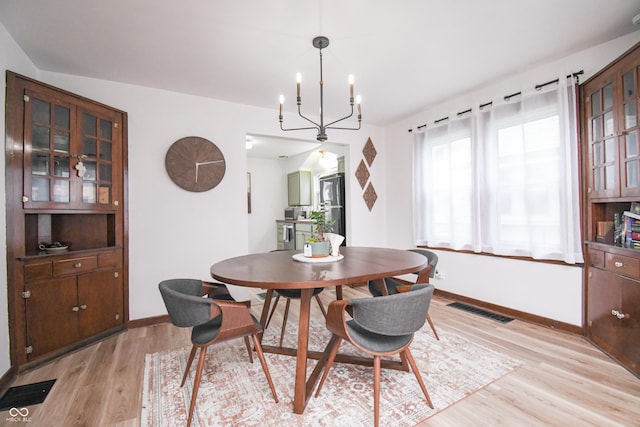 1606 California St, Columbus, IN 47201 - dining room with light wood finished floors and a chandelier