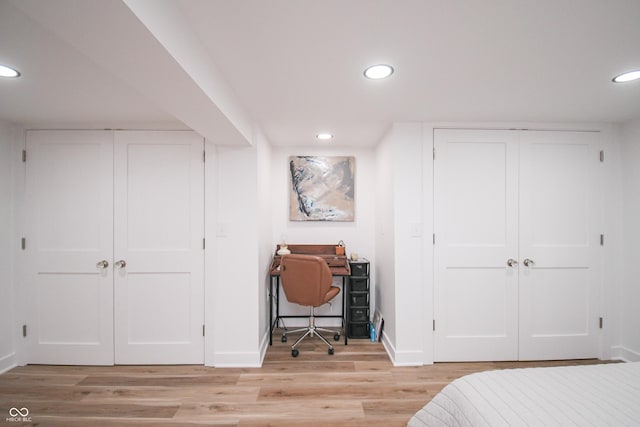 1606 California St, Columbus, IN 47201 - bedroom featuring light wood-style floors, recessed lighting, a desk, and two closets