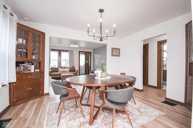 1606 California St, Columbus, IN 47201 - dining space with light wood-type flooring and a chandelier