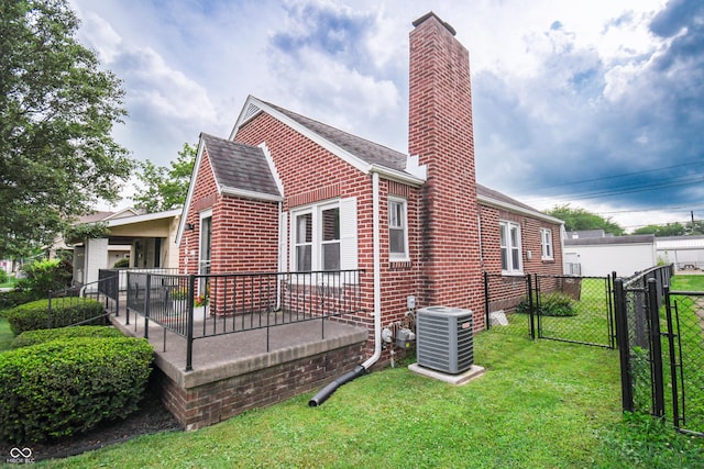 1606 California St, Columbus, IN 47201 - view of side of property featuring brick siding, a gate, a chimney, and roof with shingles