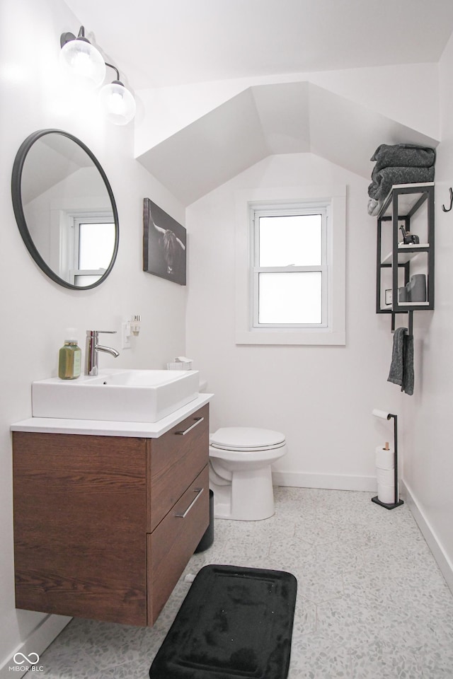 1606 California St, Columbus, IN 47201 - bathroom with vanity, speckle patterned floor, and lofted ceiling