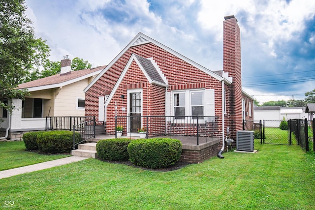 1606 California St, Columbus, IN 47201 - view of front of house featuring brick siding, a chimney, and a gate