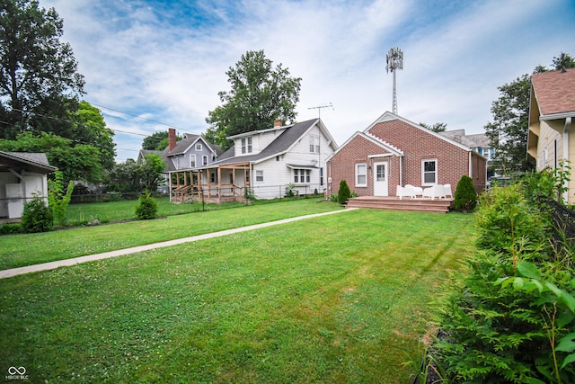 1606 California St, Columbus, IN 47201 - view of front of house with a fenced backyard, brick siding, and a deck