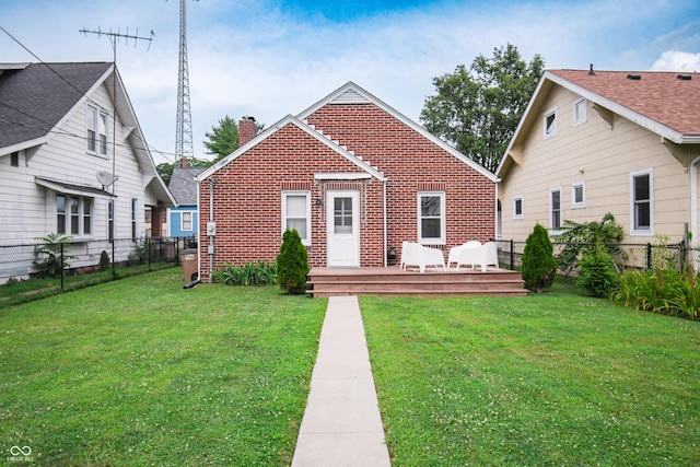 1606 California St, Columbus, IN 47201 - view of front of house featuring brick siding, a chimney, a wooden deck, and a fenced backyard