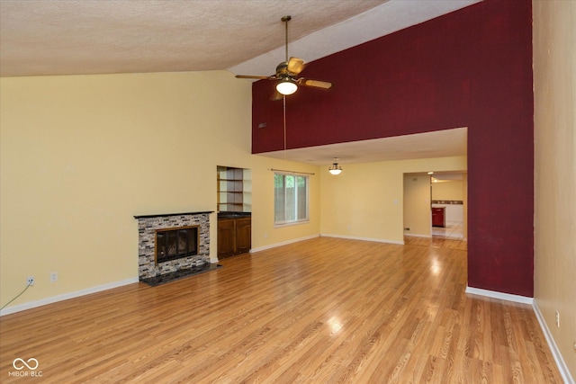 5038 Hawthorne Way, Avon, IN 46123 - unfurnished living room with high vaulted ceiling, light wood finished floors, ceiling fan, and a fireplace