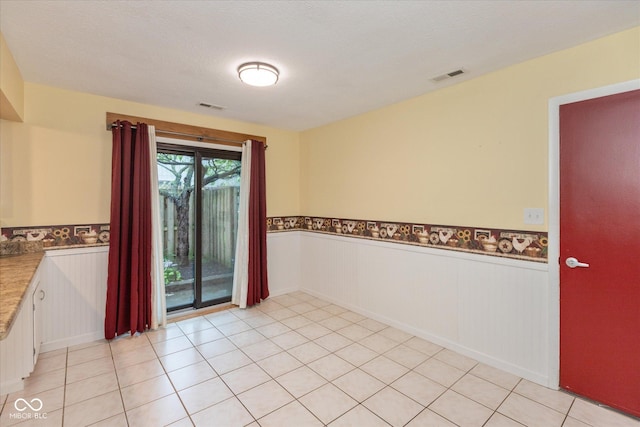 5038 Hawthorne Way, Avon, IN 46123 - spare room with a wainscoted wall and light tile patterned flooring