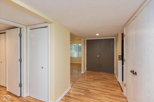 5038 Hawthorne Way, Avon, IN 46123 - hall with light wood-type flooring, a textured ceiling, and recessed lighting