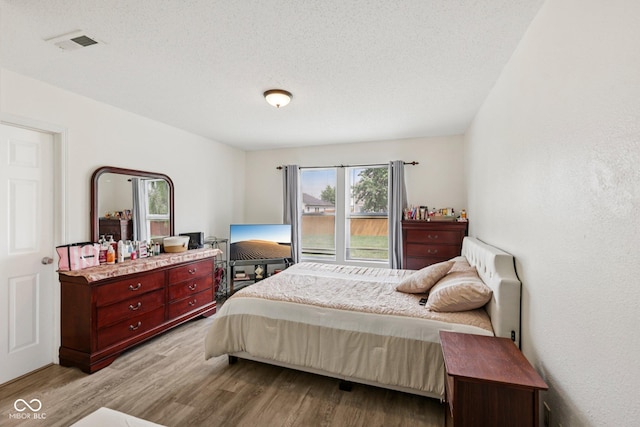 7930 Cork Bend Ln, Indianapolis, IN 46239 - bedroom featuring wood finished floors and a textured ceiling