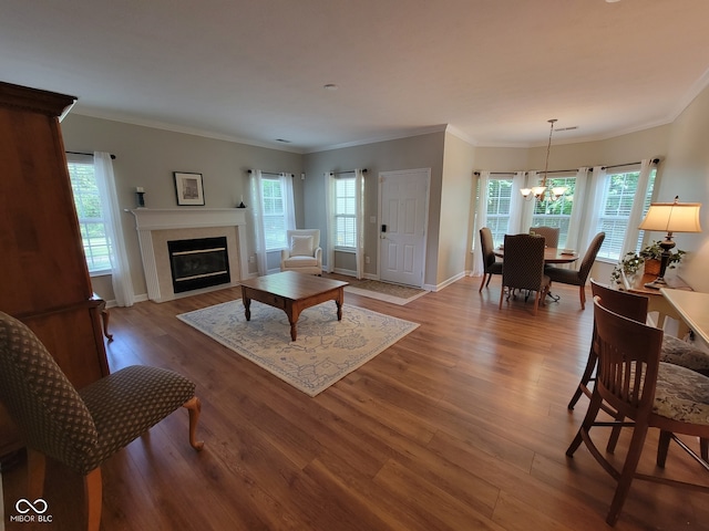 1096 Shadow Ridge Rd, Carmel, IN 46280 - living room with wood finished floors, a chandelier, a glass covered fireplace, and ornamental molding