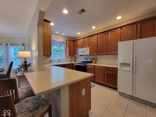 1096 Shadow Ridge Rd, Carmel, IN 46280 - kitchen featuring white appliances, a breakfast bar, light countertops, a peninsula, and light tile patterned flooring