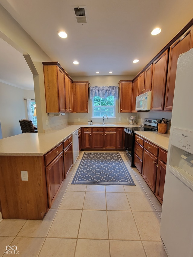 1096 Shadow Ridge Rd, Carmel, IN 46280 - kitchen with white appliances, light tile patterned flooring, recessed lighting, and brown cabinets