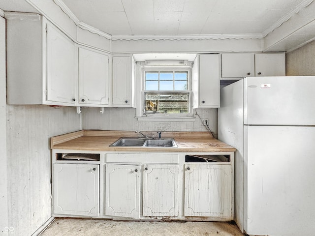 1518 S Goodlet Ave, Indianapolis, IN 46241 - kitchen featuring freestanding refrigerator, light countertops, white cabinets, and crown molding