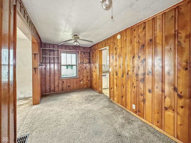1518 S Goodlet Ave, Indianapolis, IN 46241 - carpeted spare room with wood walls and ceiling fan
