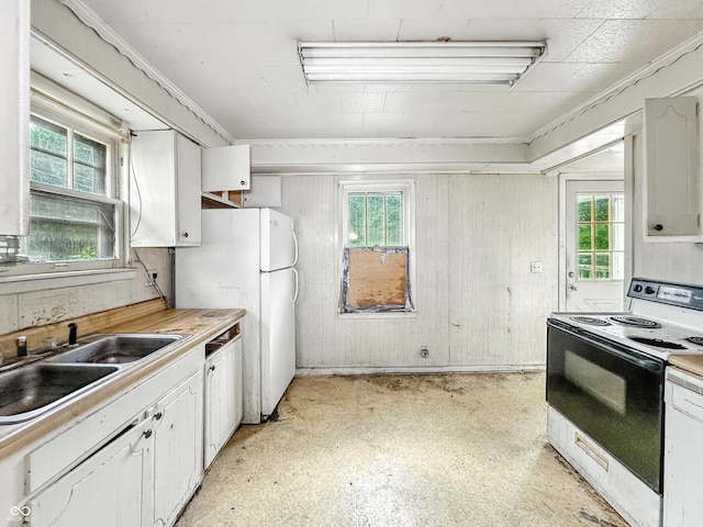 1518 S Goodlet Ave, Indianapolis, IN 46241 - kitchen with electric range oven, healthy amount of natural light, and white cabinets
