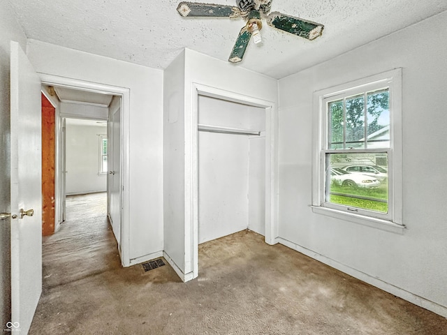1518 S Goodlet Ave, Indianapolis, IN 46241 - unfurnished bedroom with a closet, carpet floors, a textured ceiling, ceiling fan, and attic access
