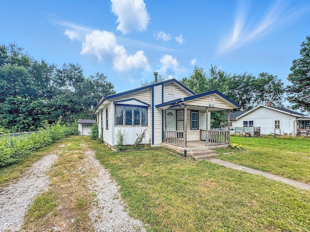 1518 S Goodlet Ave, Indianapolis, IN 46241 - bungalow-style home with a porch, a front lawn, and driveway