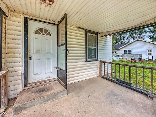 1518 S Goodlet Ave, Indianapolis, IN 46241 - doorway to property featuring a porch and faux log siding