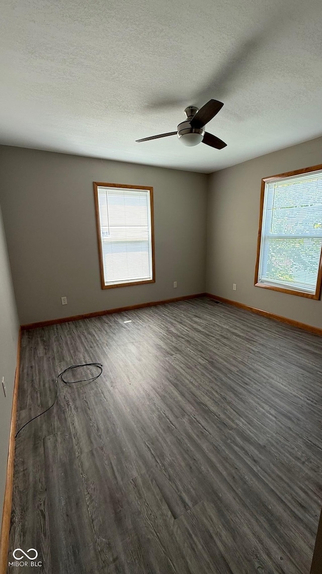 9 E Reel Ave, Vincennes, IN 47591 - empty room featuring plenty of natural light, wood finished floors, a ceiling fan, and a textured ceiling