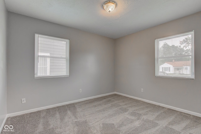 3426 N Olney St, Indianapolis, IN 46218 - carpeted empty room featuring baseboards