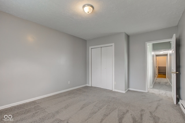 3426 N Olney St, Indianapolis, IN 46218 - unfurnished bedroom featuring a textured ceiling, carpet floors, and a closet