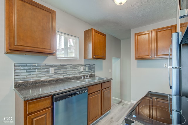 3426 N Olney St, Indianapolis, IN 46218 - kitchen featuring dishwasher, electric range oven, dark countertops, light wood finished floors, and tasteful backsplash