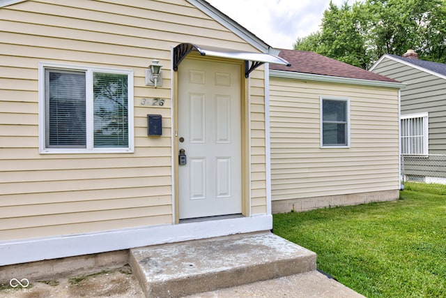 3426 N Olney St, Indianapolis, IN 46218 - entrance to property featuring a lawn and roof with shingles