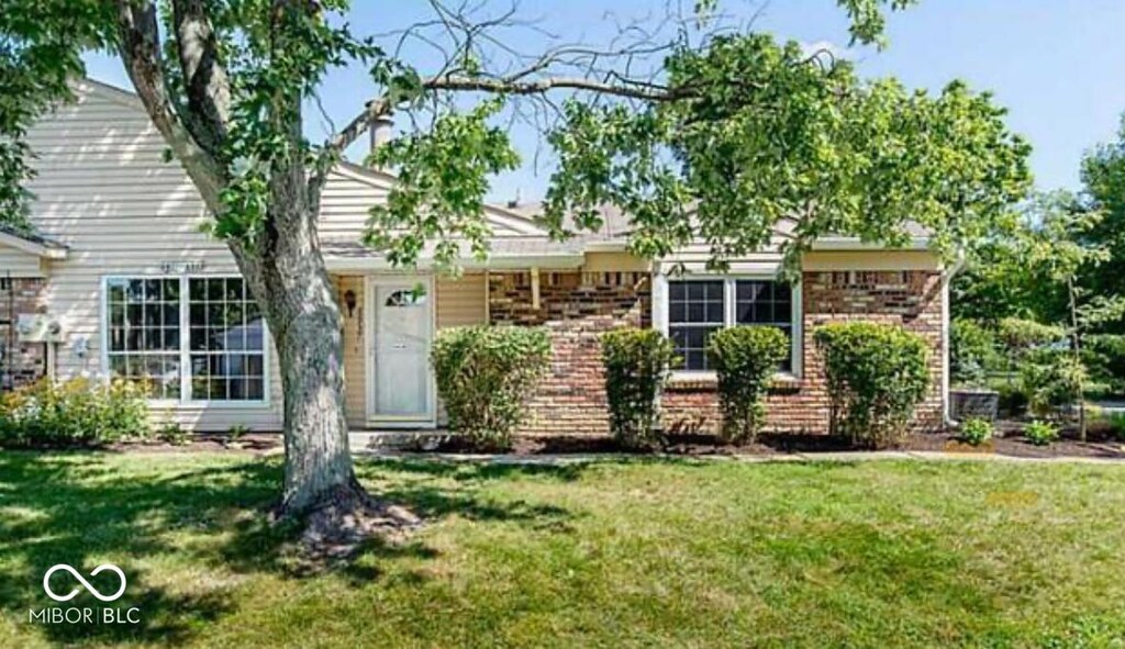 6937 Wildwood Ct, Indianapolis, IN 46268 - view of front of home with a front lawn and brick siding
