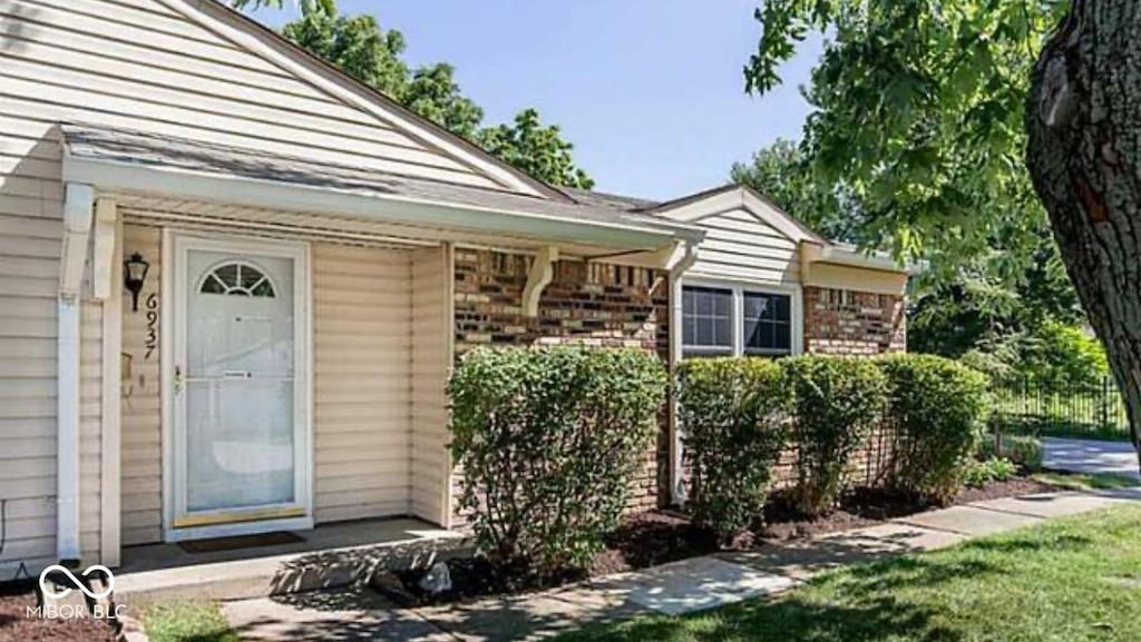 6937 Wildwood Ct, Indianapolis, IN 46268 - doorway to property with brick siding