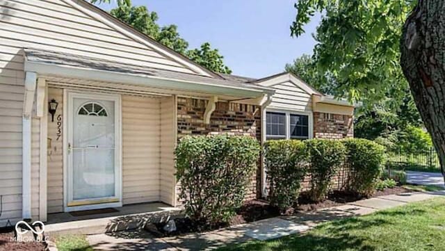 6937 Wildwood Ct, Indianapolis, IN 46268 - doorway to property with brick siding