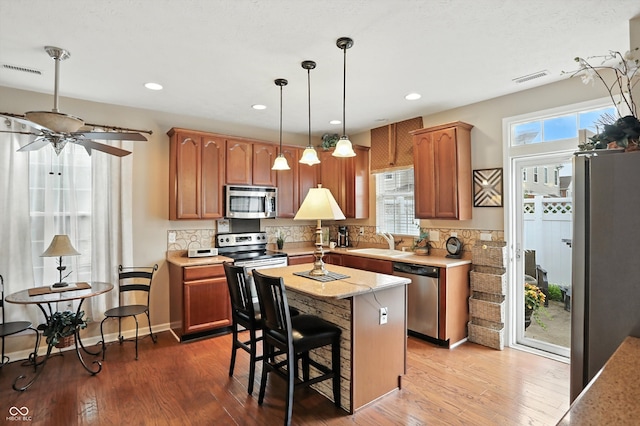 13534 E 131st St, Fishers, IN 46037 - kitchen featuring appliances with stainless steel finishes, tasteful backsplash, pendant lighting, a kitchen island, and recessed lighting