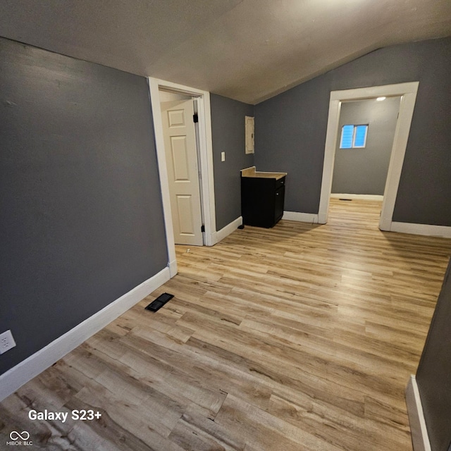 1206 W 25th St, Indianapolis, IN 46208 - unfurnished room with vaulted ceiling and light wood finished floors