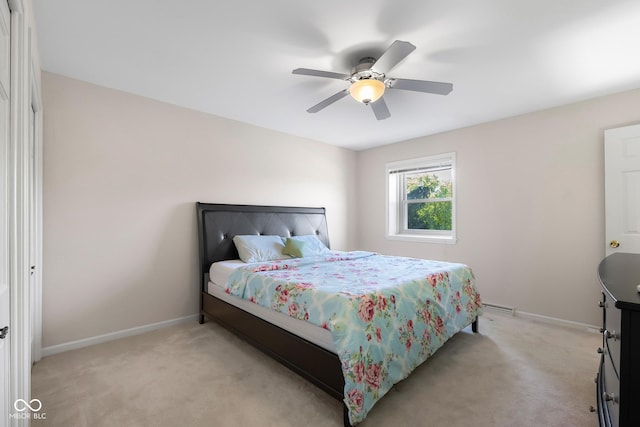 3905 Cove Rd, Columbus, IN 47203 - bedroom with light carpet, ceiling fan, and a baseboard heating unit