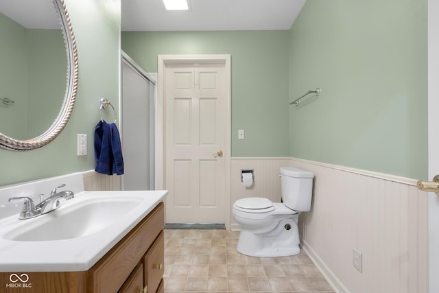 3905 Cove Rd, Columbus, IN 47203 - bathroom featuring a wainscoted wall, vanity, and an enclosed shower