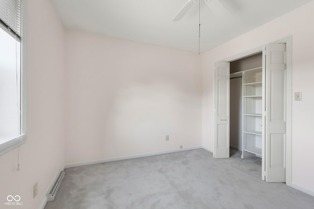 3905 Cove Rd, Columbus, IN 47203 - unfurnished bedroom with light carpet, a baseboard radiator, and ceiling fan