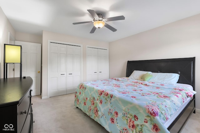 3905 Cove Rd, Columbus, IN 47203 - bedroom with two closets, light colored carpet, and a ceiling fan