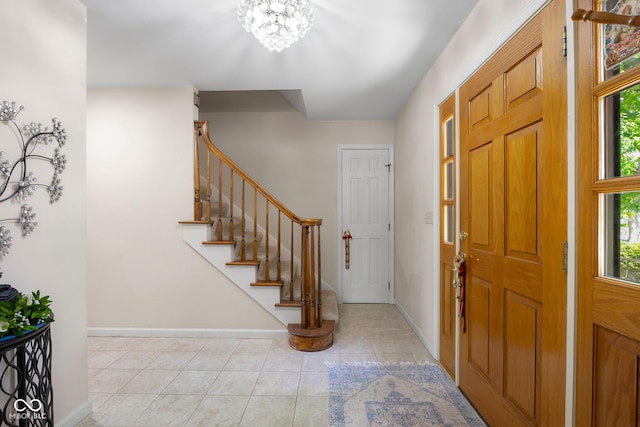 3905 Cove Rd, Columbus, IN 47203 - entrance foyer with stairway, light tile patterned floors, and a chandelier