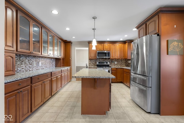 3905 Cove Rd, Columbus, IN 47203 - kitchen with stainless steel appliances, backsplash, light stone counters, glass insert cabinets, and recessed lighting